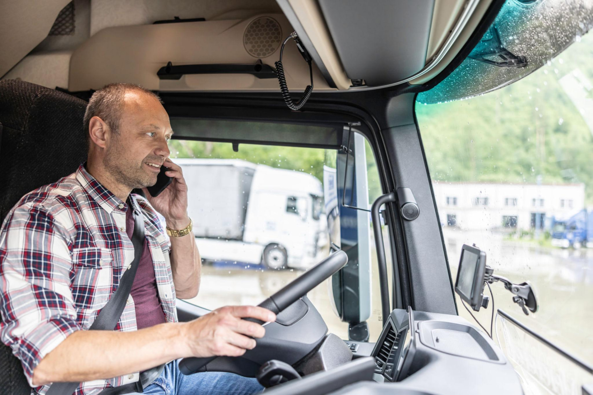 Truck driver coordinating loads from the cab